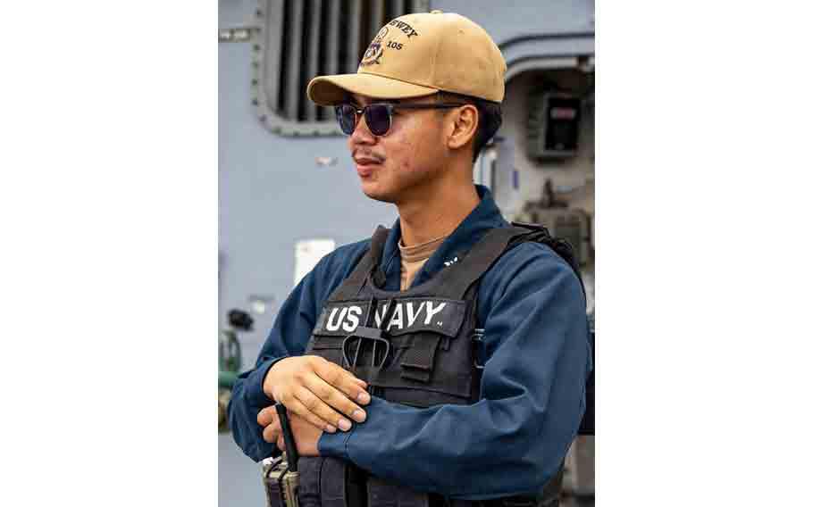 U.S. Navy Logistics Specialist 2nd Class Raymond Imperial stands watch on midships aboard Arleigh Burke-class guided-missile destroyer USS Dewey during a sea and anchor evolution while departing Okinawa, Japan.